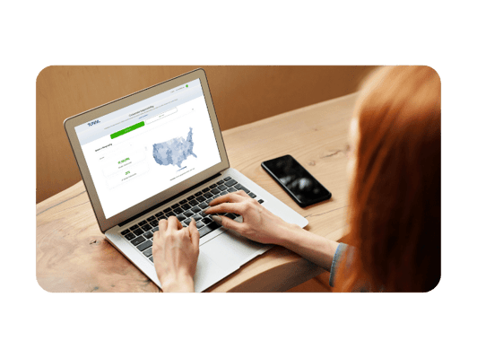 Woman with read hair using laptop with Tunnl platform