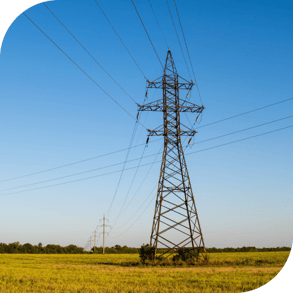 a cable tower in a rural area against a blue sky