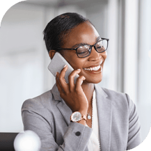 Business woman smiling on the phone dressed in a suit