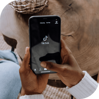 Person looking at a TikTok loading screen on a smart phone