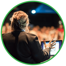 Woman speaking to large audience