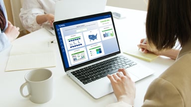 Woman using the Tunnl platform on a laptop looking at an audience insights dashboard for the prebuilt Opinion Leaders audience