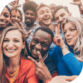 a diverse group of people smile for a selfie