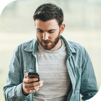 Man looking at his phone as he receives an SMS or phone ad campaign from a public affairs or issue advocacy advertiser.