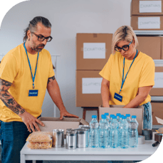 Members of the same company volunteer at a food bank