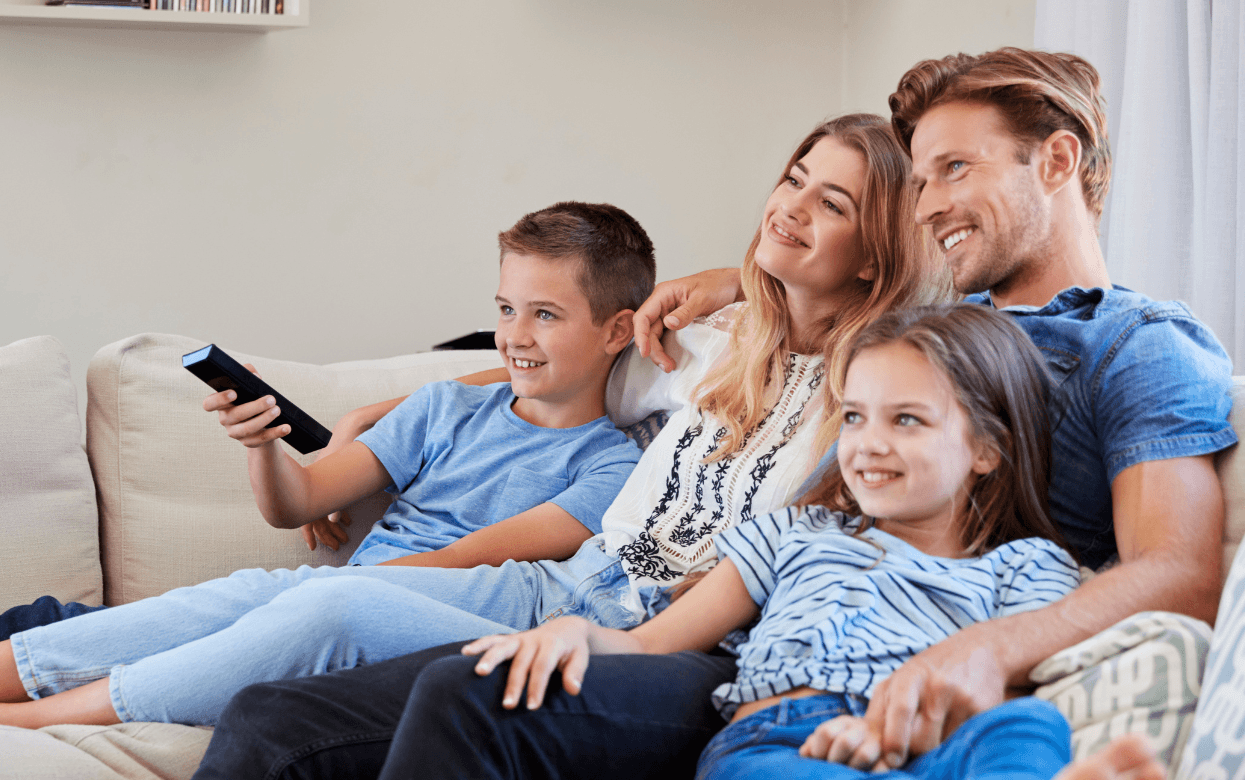 Family watching TV on couch