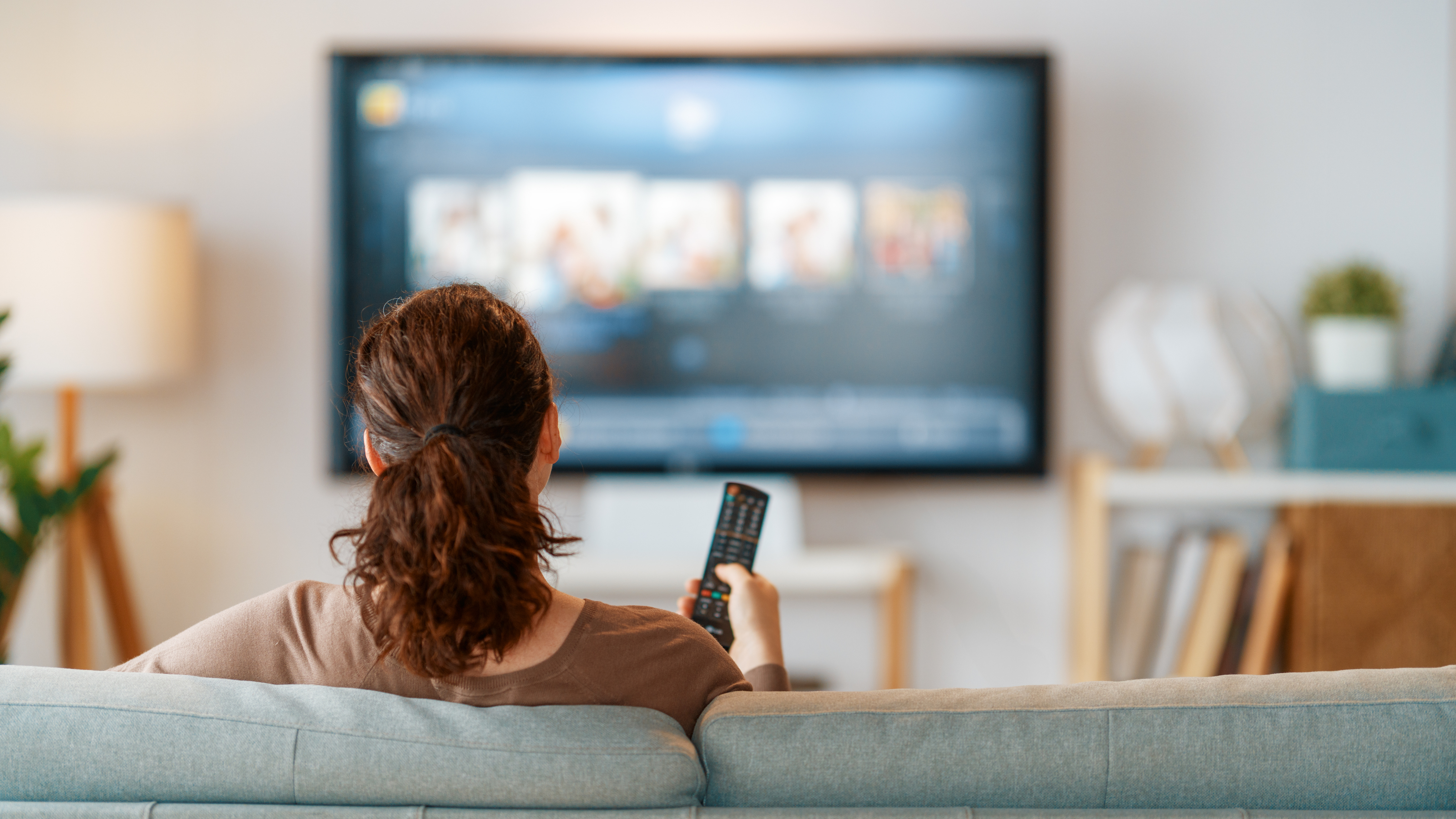 Woman watching TV on couch